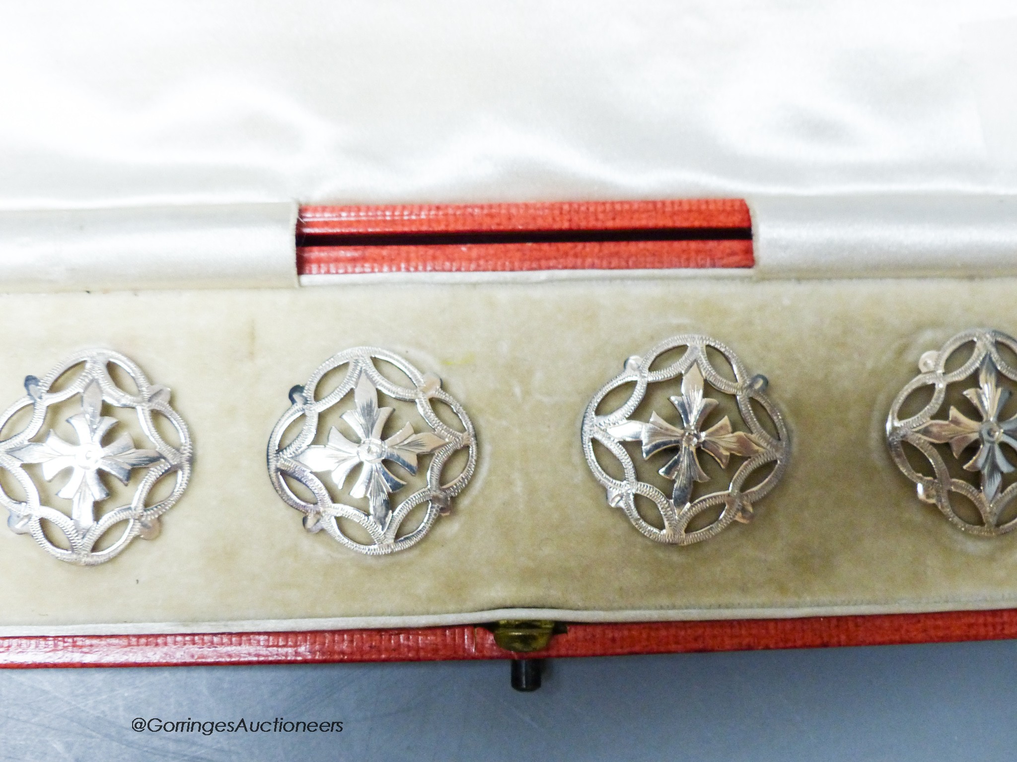 An Edwardian cased set of six pierced silver dress buttons, John Tiley, London, 1902, 25mm.